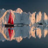 Greenland midnight Sunset iceberg perfect reflection panorama wi